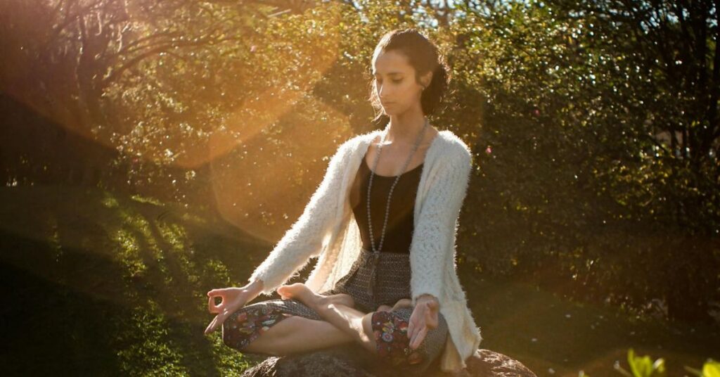 imagen de una chica meditando en total calma y en plena naturaleza